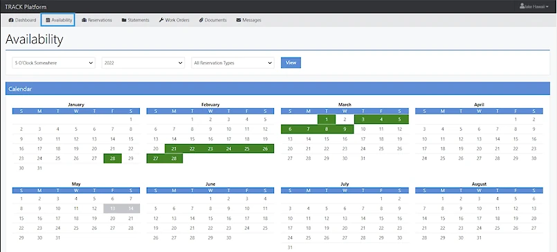 A calendar interface showing availability across months with green blocks on booked days and a top toolbar for filters and view options.